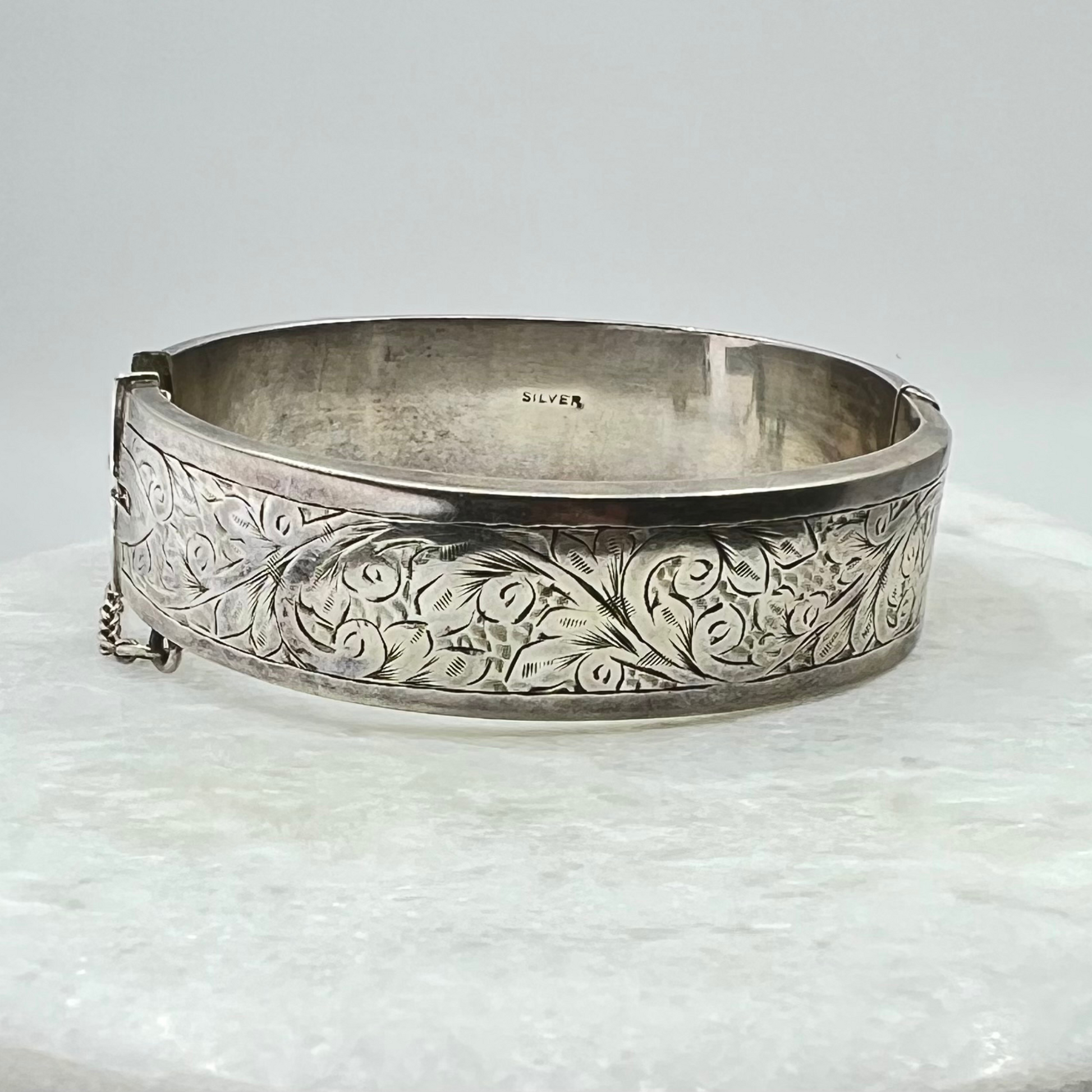 Vintage silver hand-etched hinged bangle with button clip and safety chain. Hudsons Estate Jewellery