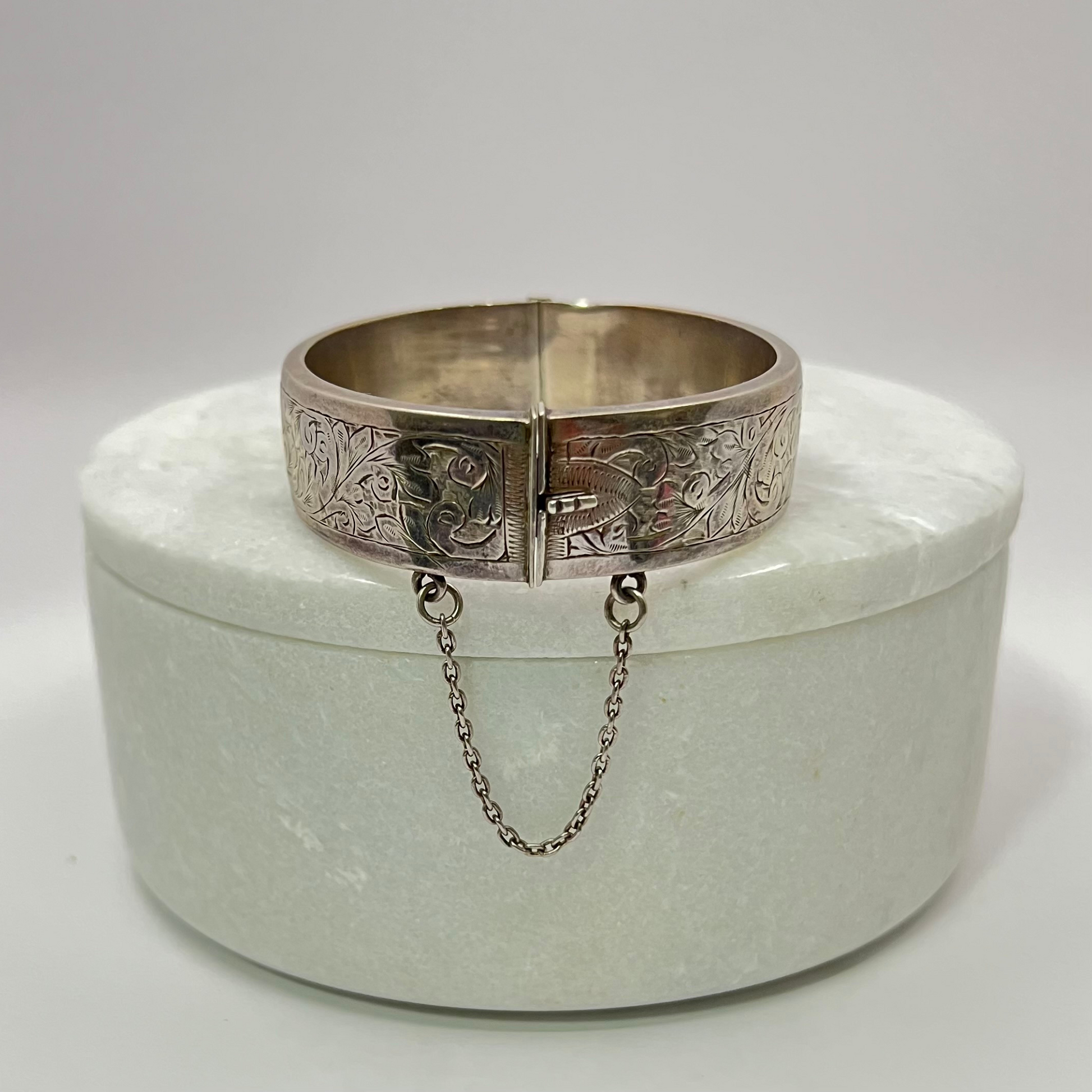 Vintage silver hand-etched hinged bangle with button clip and safety chain. Hudsons Estate Jewellery